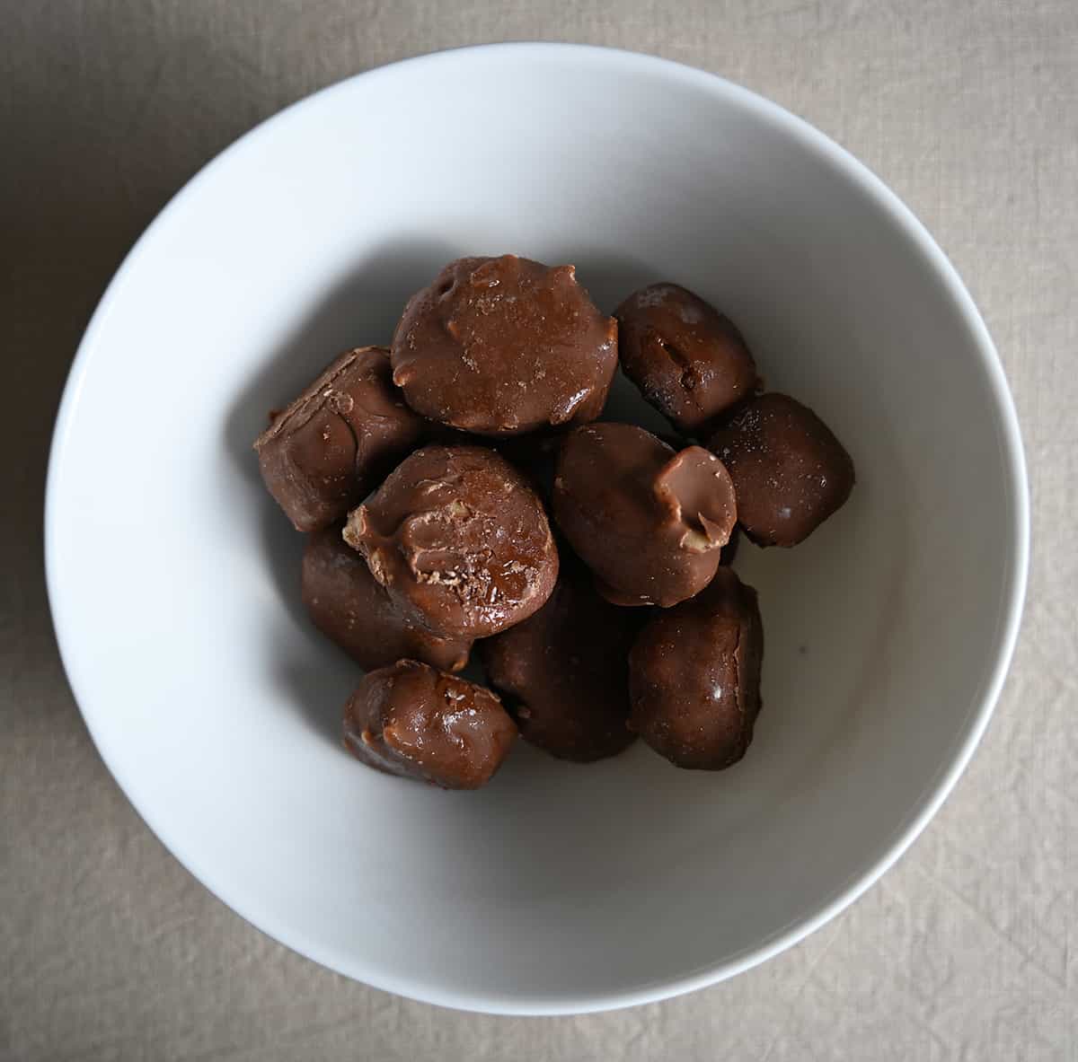 Top down image of a bowl full of Reese's frozen banana slices.