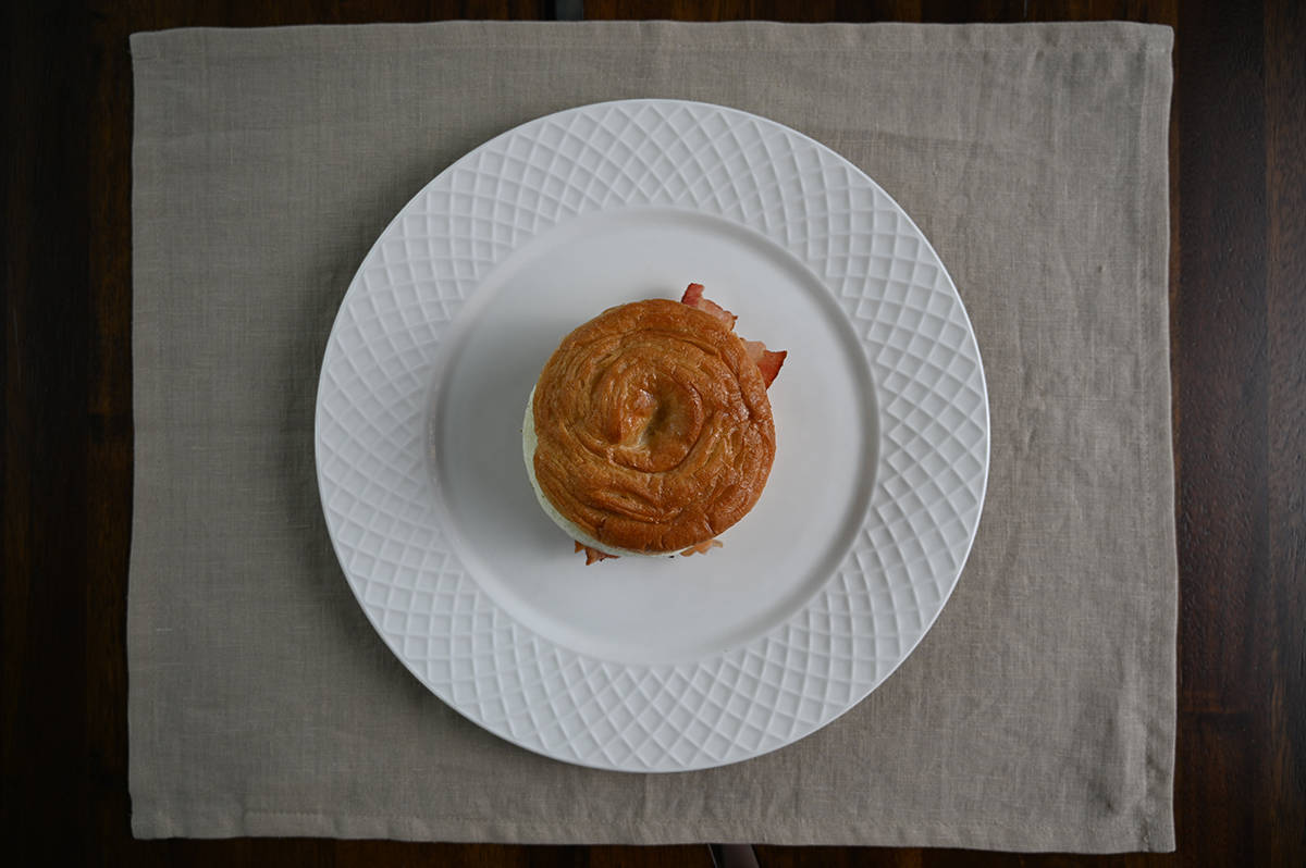 Top down image of one Kirkland Signature Breakfast Sandwich served on a white plate.