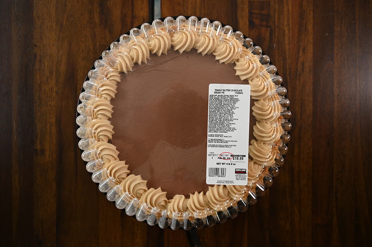Top down image of the Costco Kirkland Signature Peanut Butter Chocolate Cream Pie unopened sitting on a table.