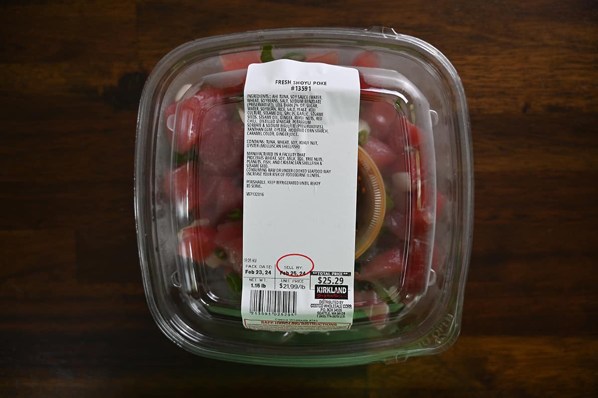Top down image of an unopened container of Fresh Shoyu Poke sitting on a table.