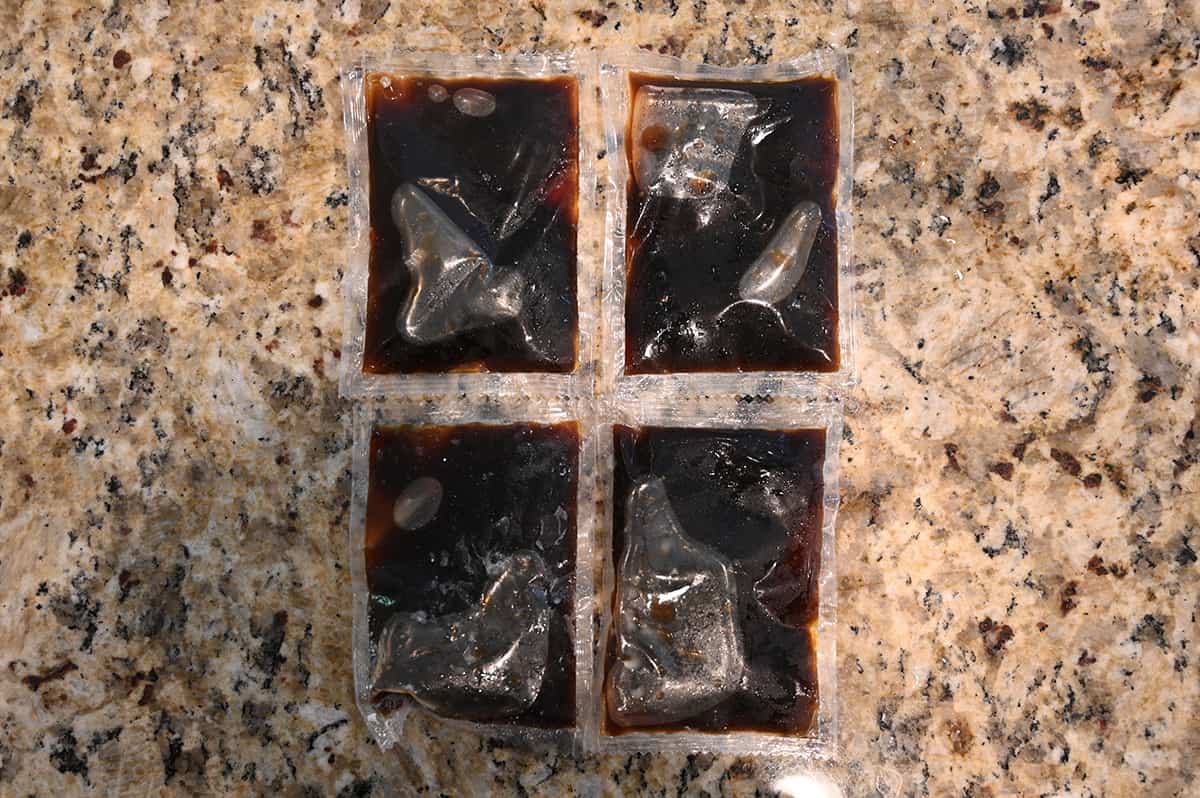 Image of four sauce packets that come in the bag of the potsticker sitting on a table unopened.