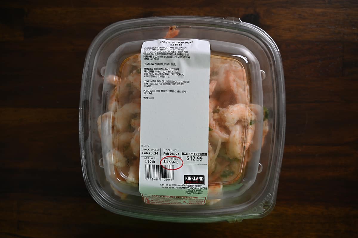 Top down image of an unopened container of Garlic Shrimp Poke sitting on a table.