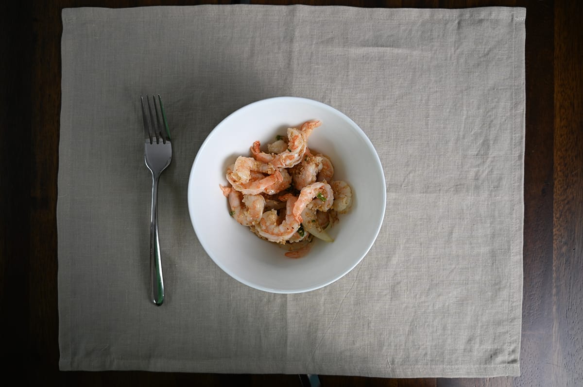 Top down image of a bowl of Garlic Shrimp Poke. There is a fork next to the bowl. 