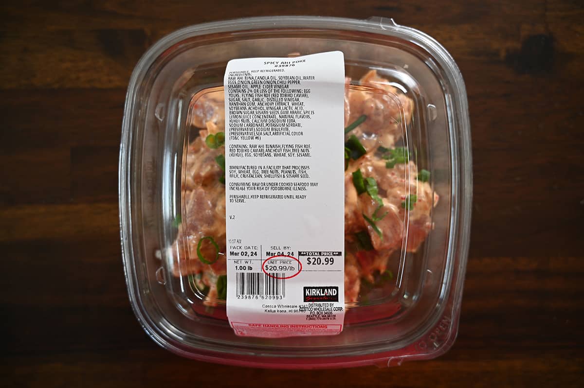 Top down image of an unopened container of Spicy Ahi Poke sitting on a table.