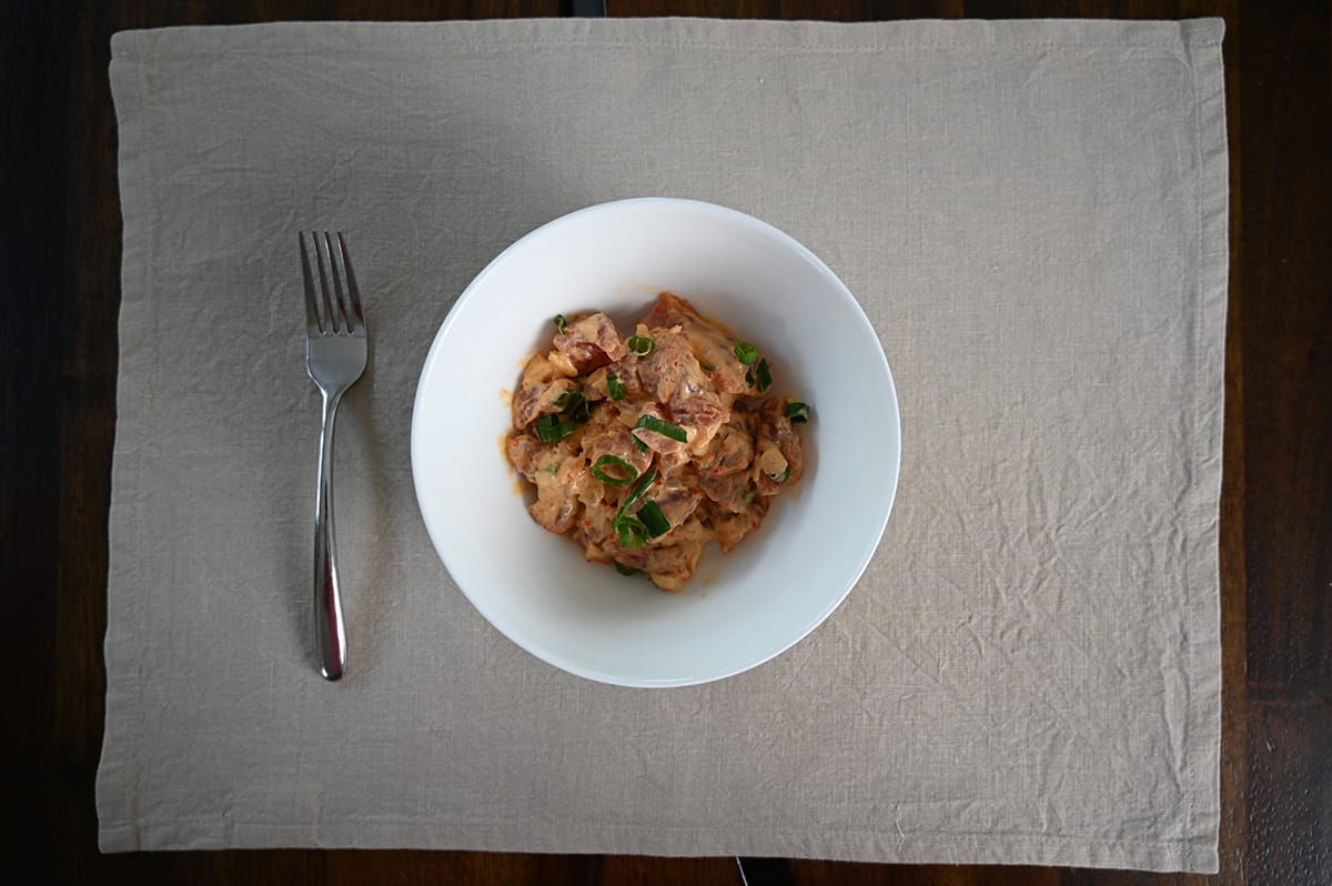 Top down image of a bowl of Spicy Ahi Poke. There is a fork next to the bowl. 