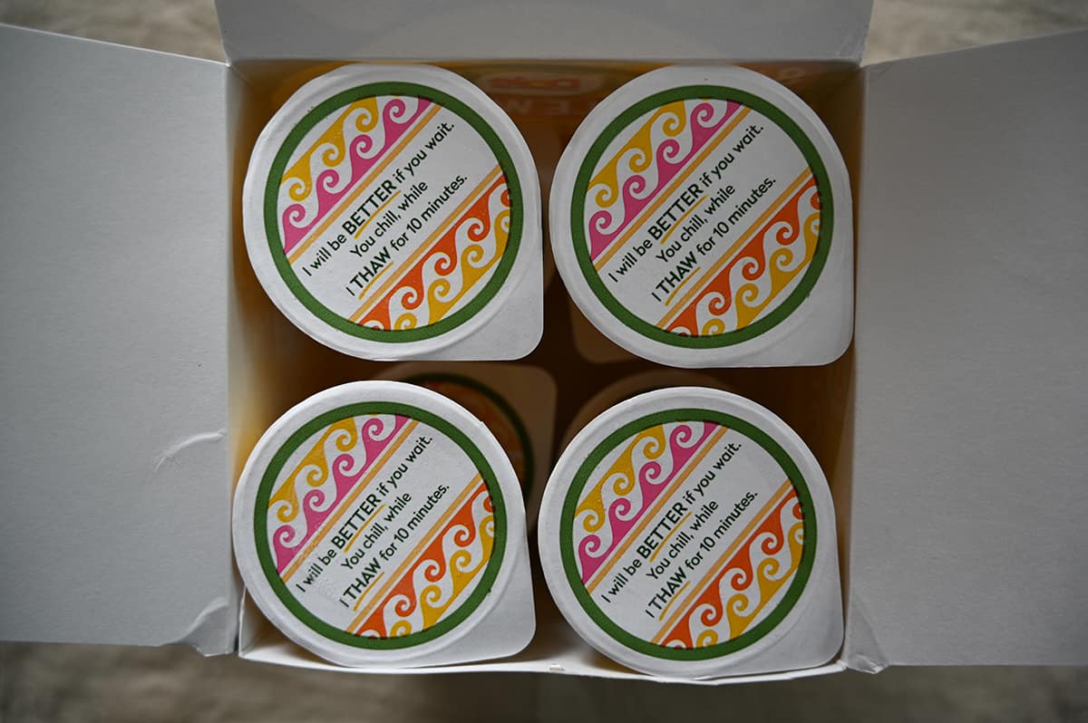 Top down image of the opened box of Dole Whip showing four individual sealed cups of frozen dessert in the top of the box.