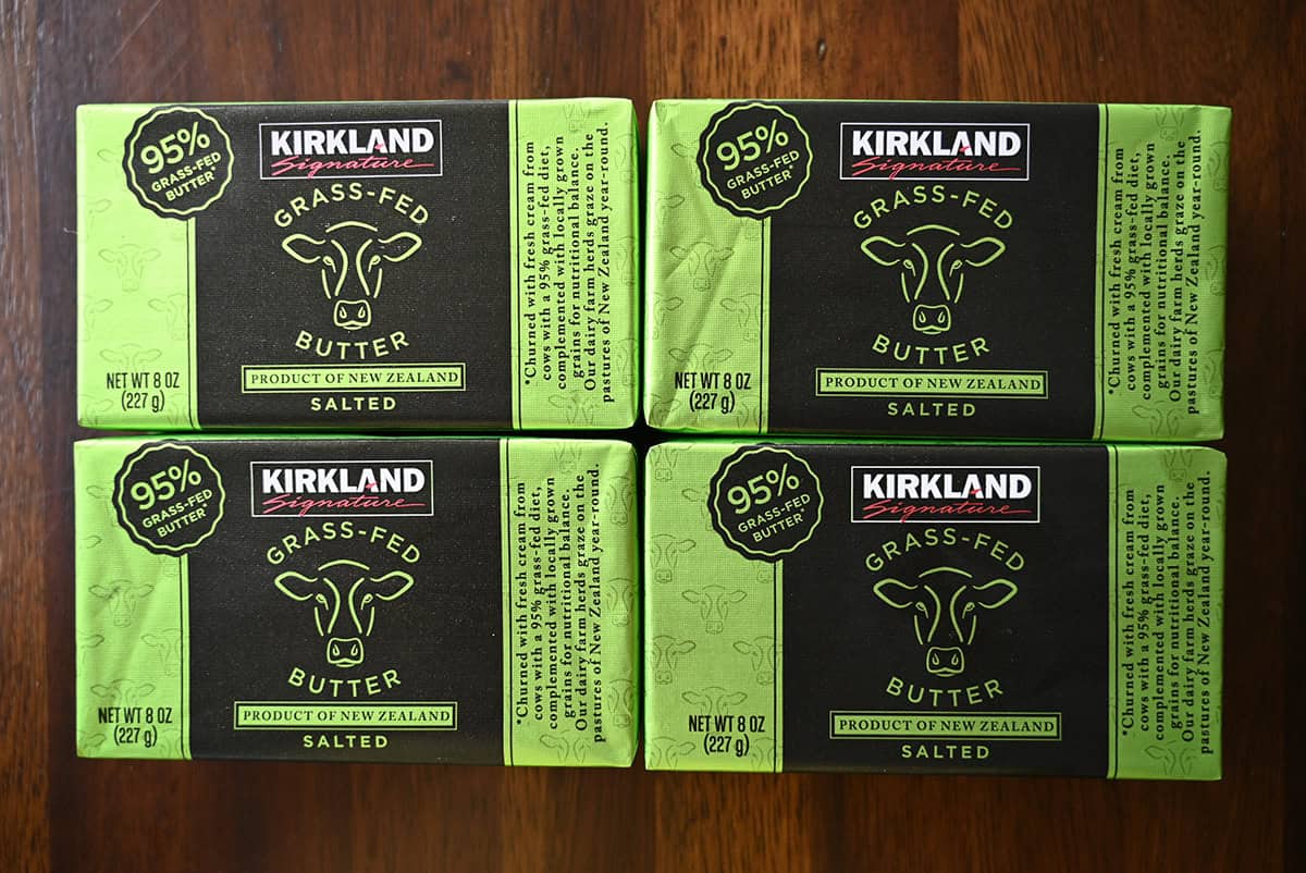 Top down image of four individually wrapped blocks of butter sitting on a table.