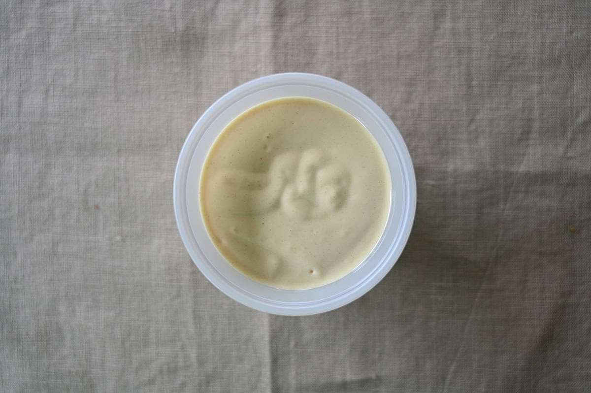 Top down image of a round container of sandwich dipping sauce.