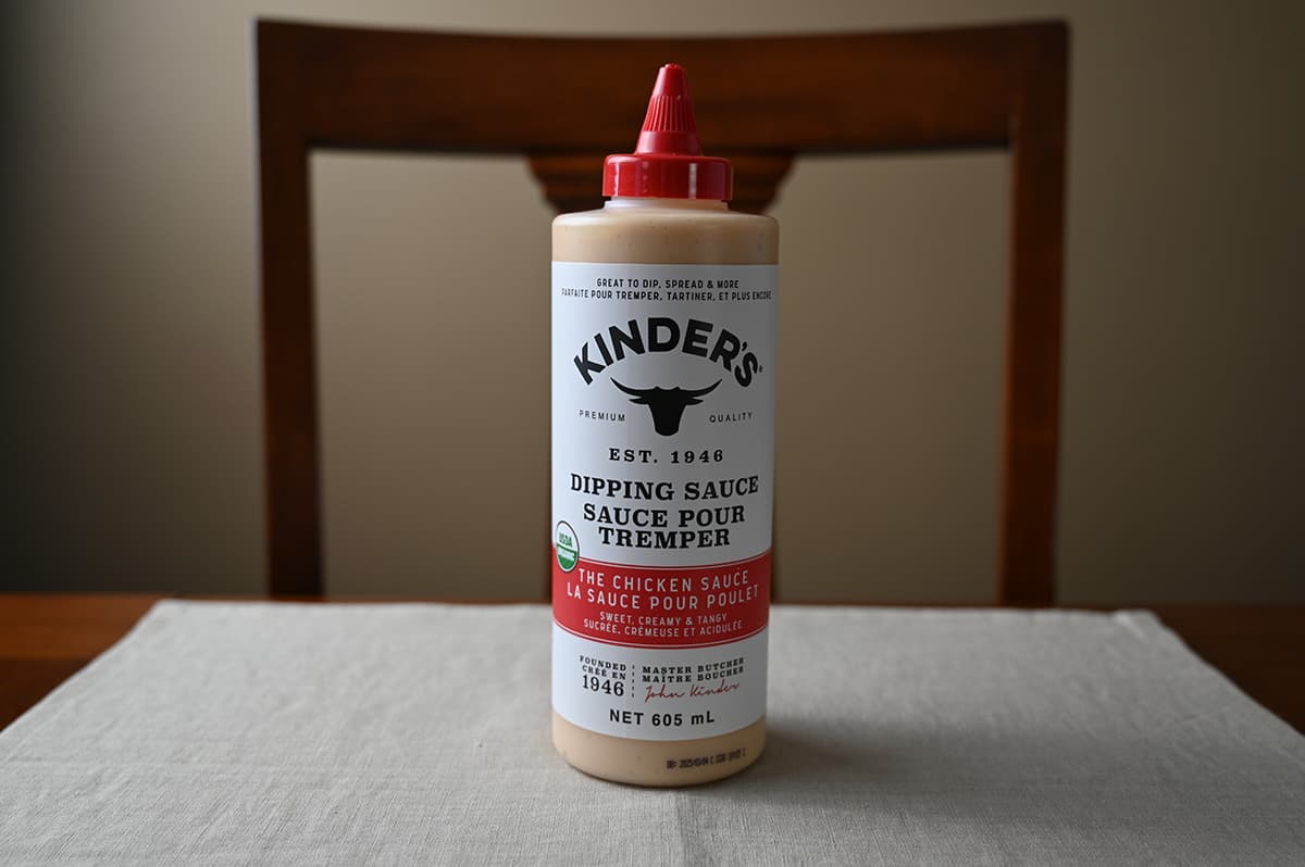 Image of the Costco Kinder's The Chicken Sauce Dipping Sauce container sitting on a table unopened. 