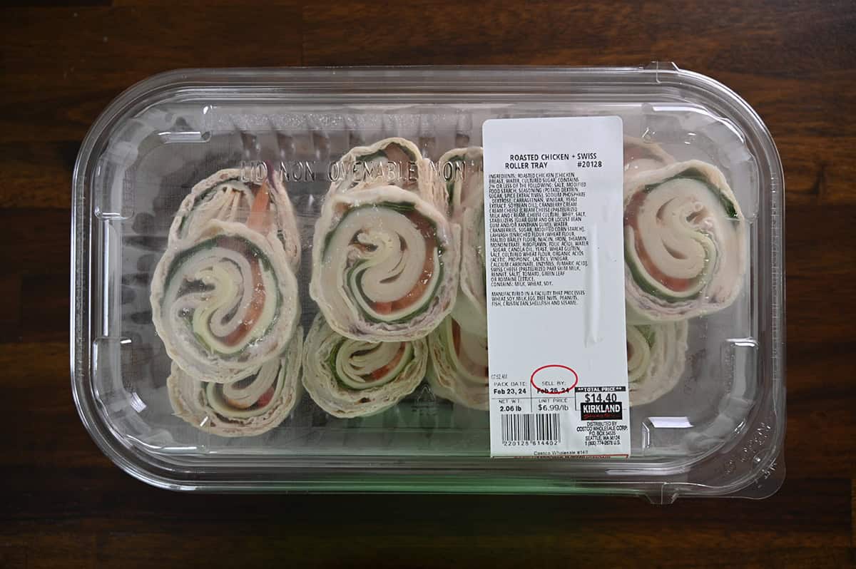Image of the Costco Kirkland Signature Roasted Chicken & Swiss Roller Tray sitting on a table unopened.
