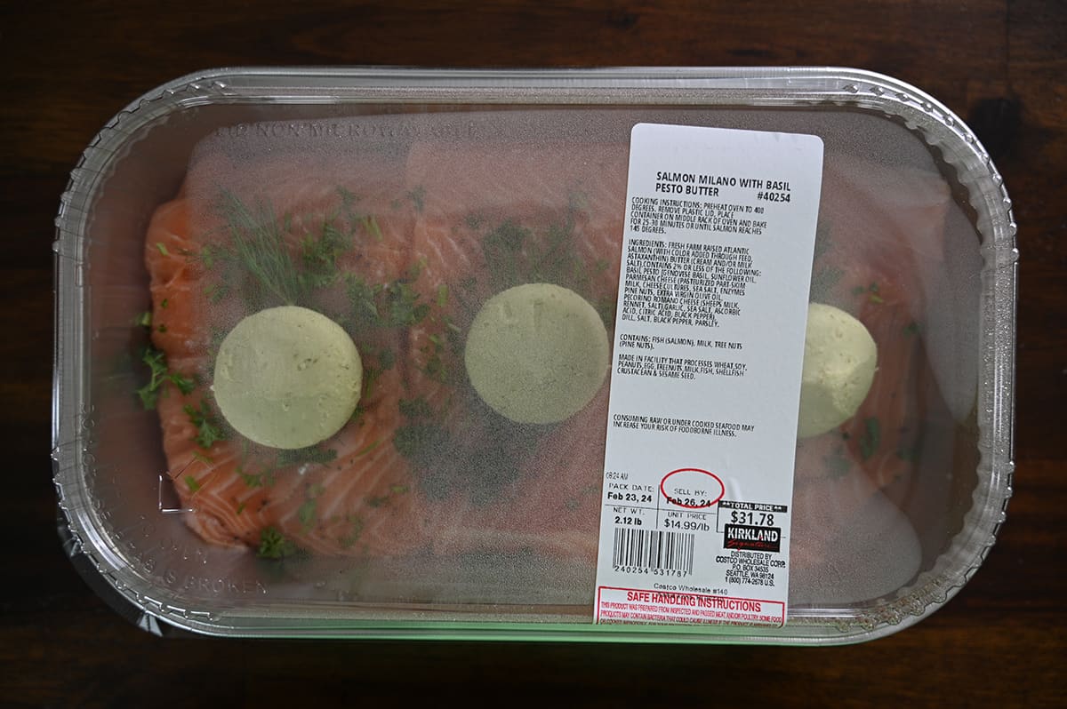 Image of the Costco Kirkland Signature Salmon Milano With Basil Pesto Butter sitting on a table unopened.