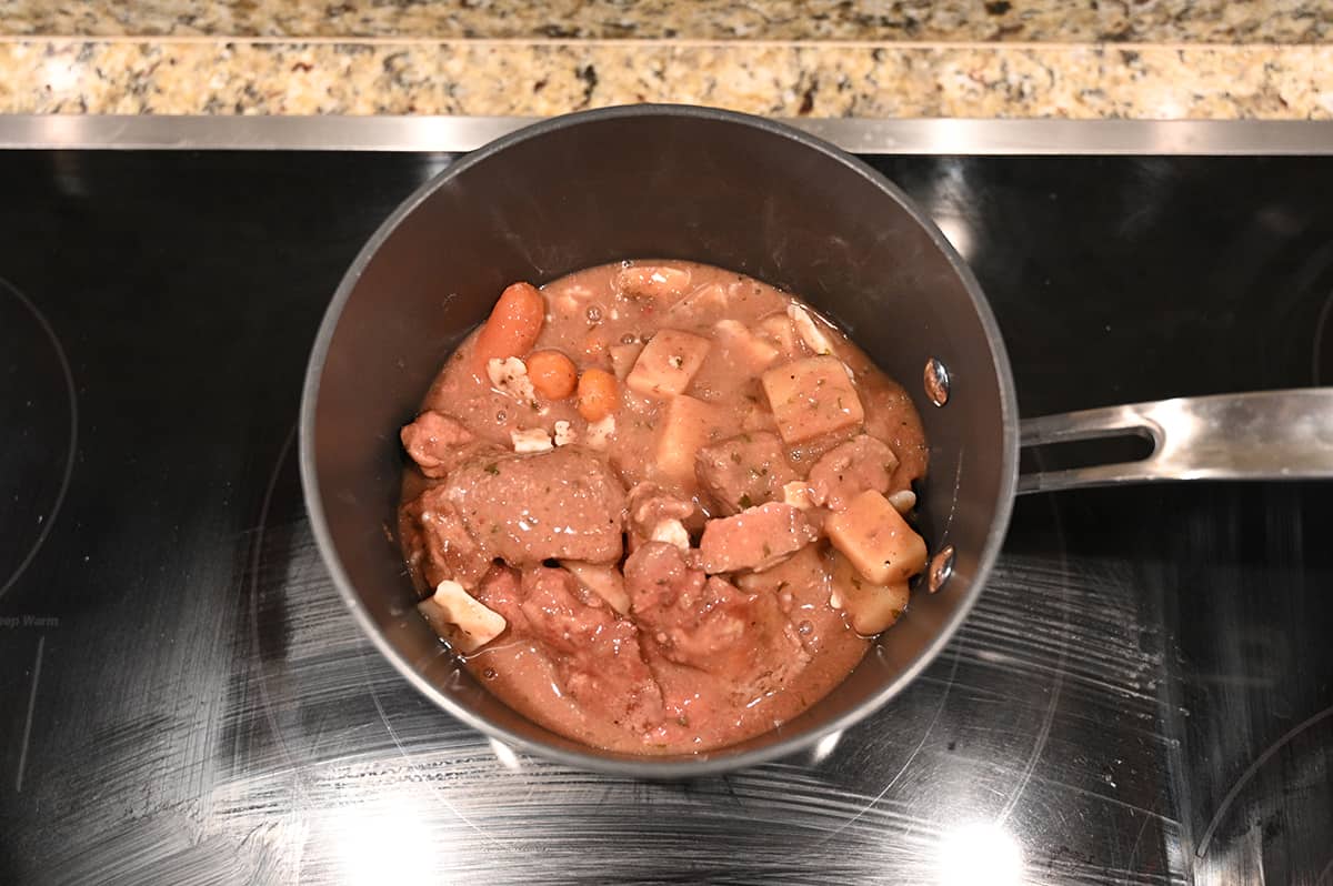 Top down image of stew simmering in a saucepan on top of the stove.