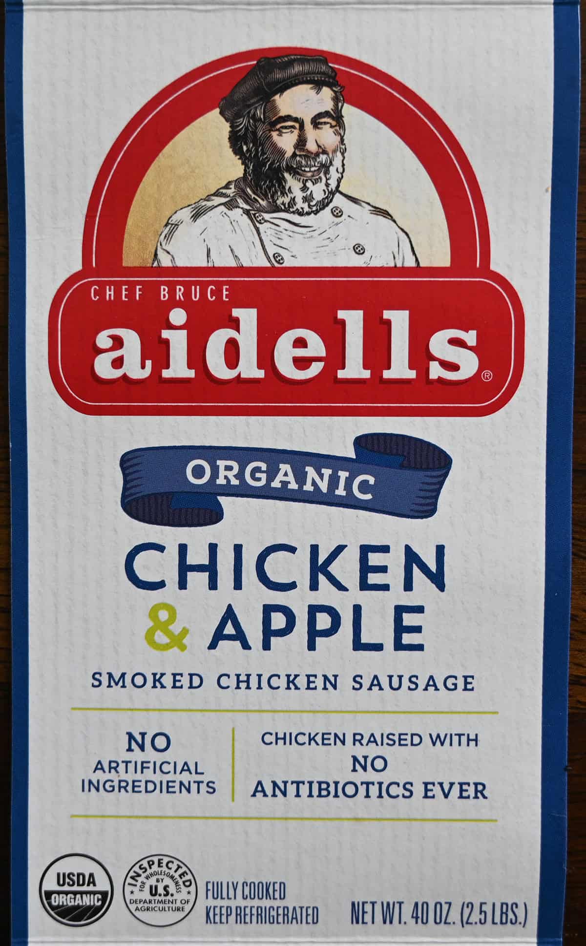 Closeup image of the front label of the sausages showing the weight of the pack as well as the sausages are organic and fully cooked.
