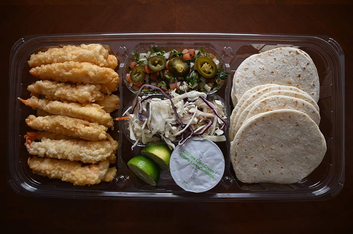 Top down image of the Costco Kirkland Signature Shrimp Tempura Tacos container sitting on a table open so you can see the contents inside.