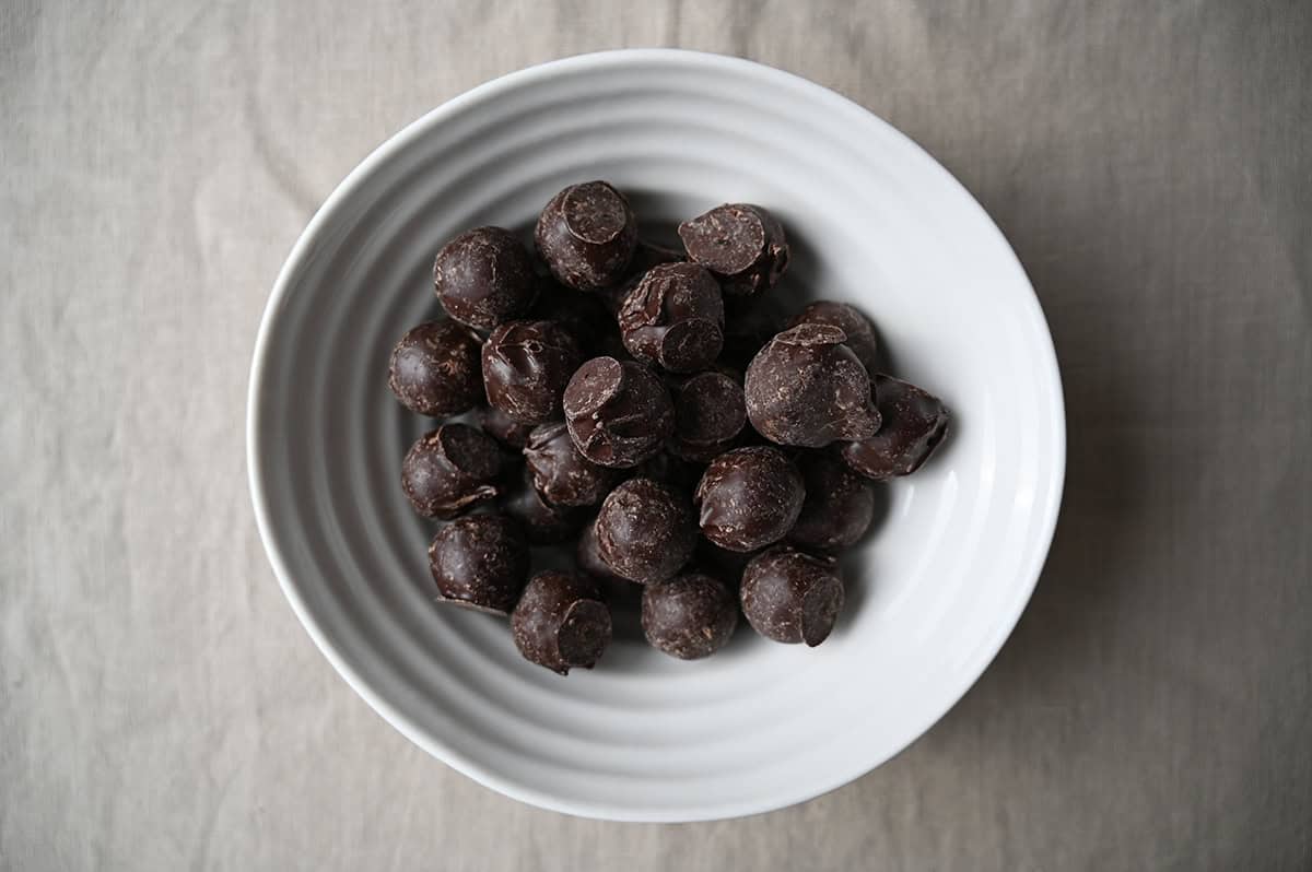Top down image of white bowl filled with chocolate truffles.