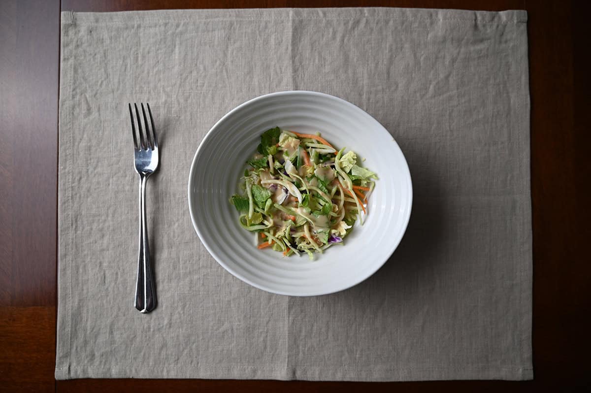 Top down image of a bowl of salad with the dressing & marinade on it.
