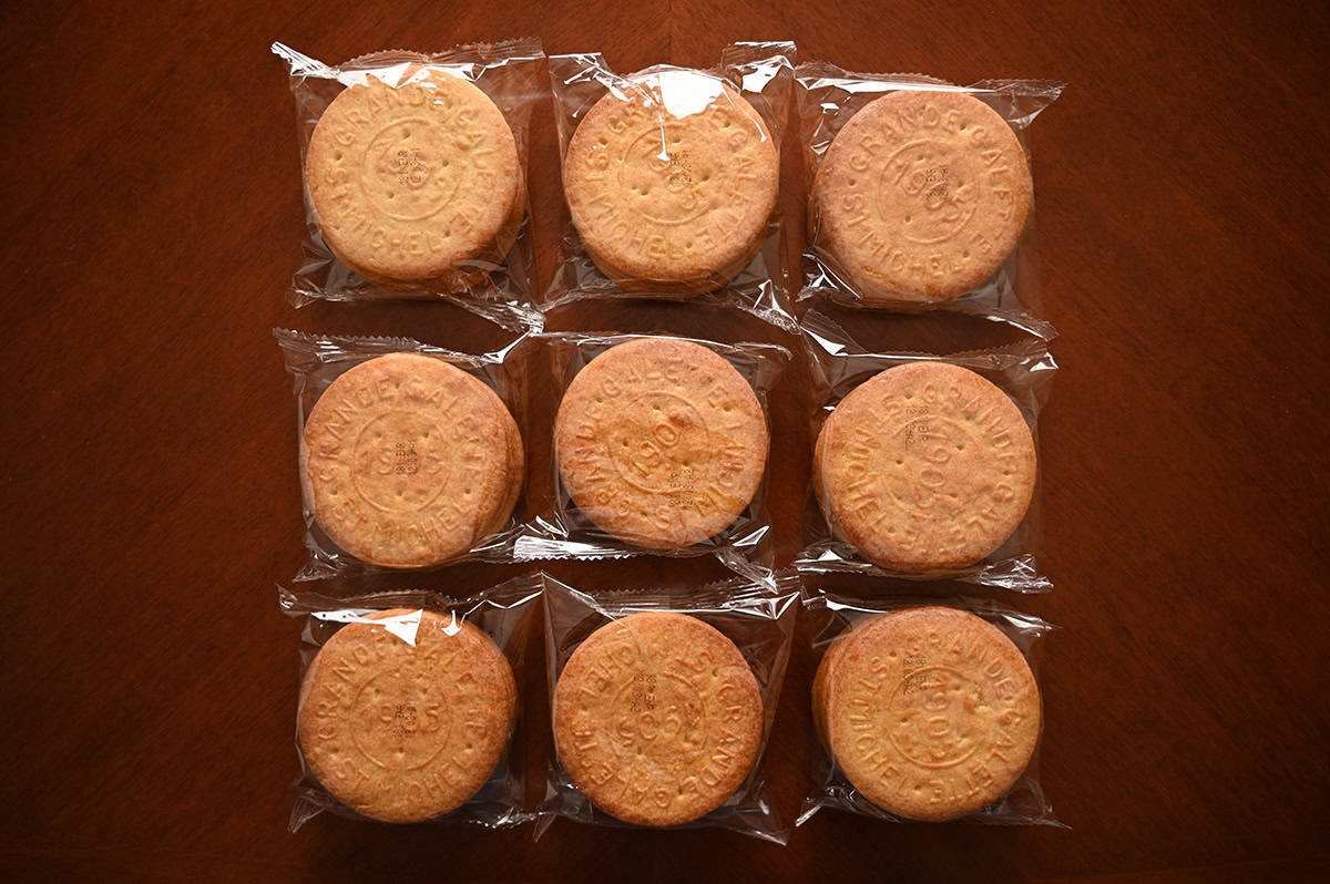 Image of nine plastic packages of cookies sitting on top of a table, unopened.