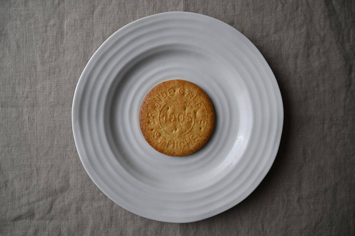 Image of one biscuit served on a white plate.