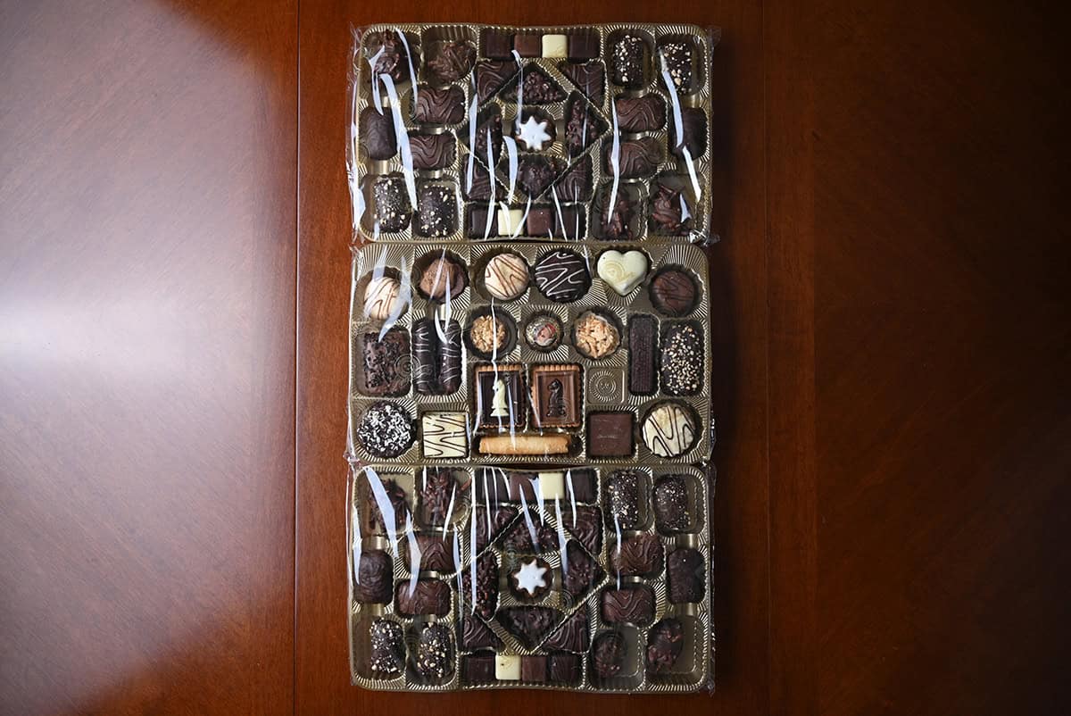 Image of three unwrapped trays of gingerbreads, cookies and confectionaries that come in the box.