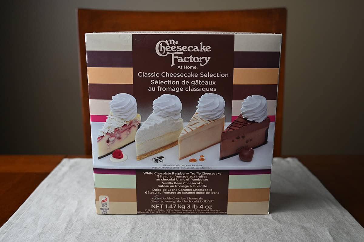 Image of the Costco The Cheesecake Factory Classic Cheesecake Selection box sitting on a table unopened.