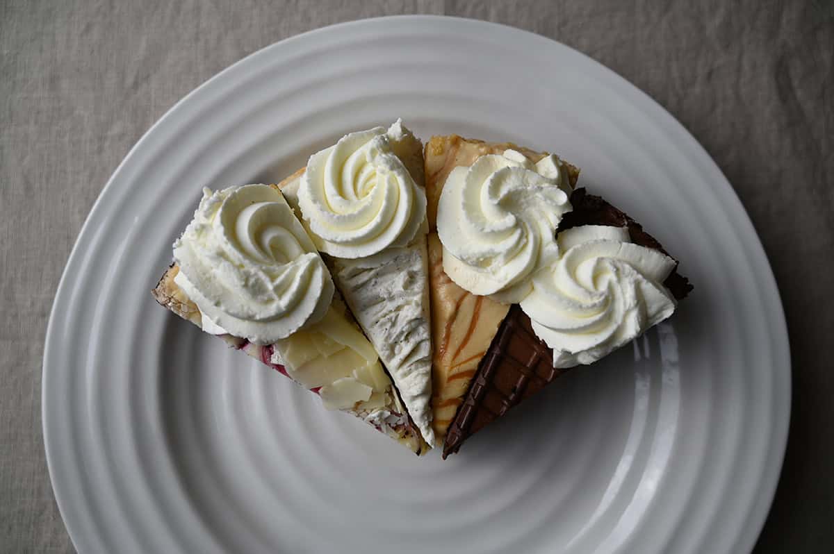 Top down image of four slices of cheesecake served on a plate.