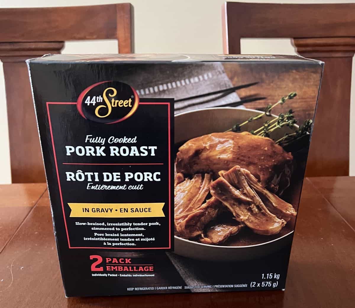 Image of the Costco 44th Street Fully Cooked Pork Roast box sitting on a table unopened. 