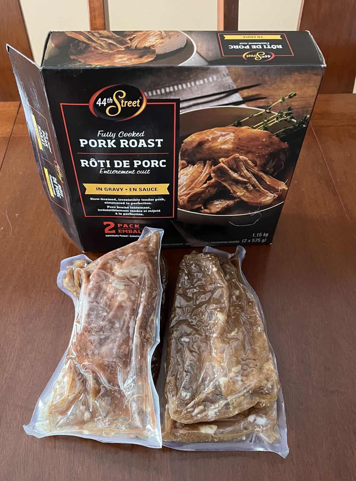Image of the 44th Street Fully Cooked Pork Roast box with two vacuum sealed pork roasts in front of the box.