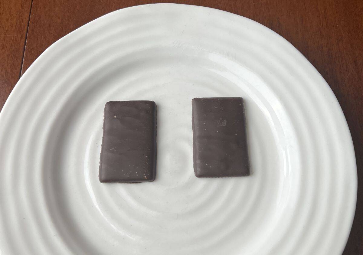 Image of two dark chocolate fruit thins served on a white plate.