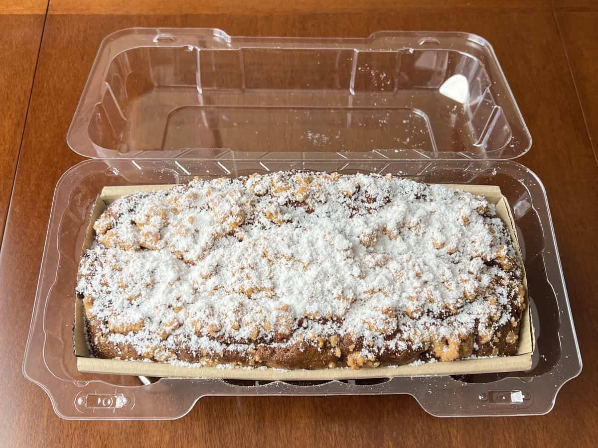 Image of the loaf in its plastic container opened so you can see the top of the loaf.