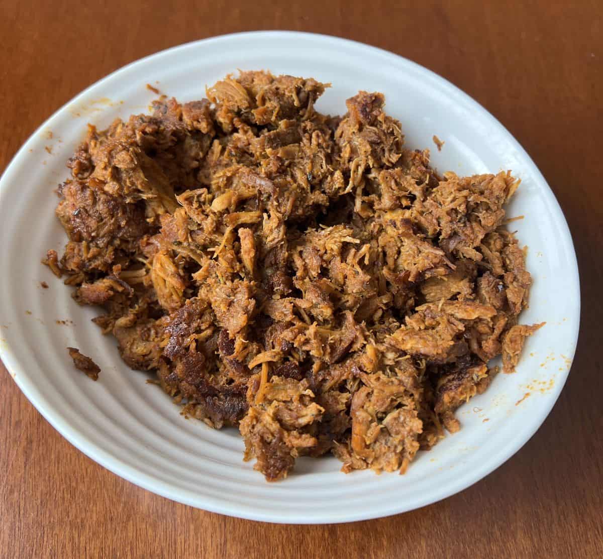 Image of a bowl of pork carnitas after it has been heated up.