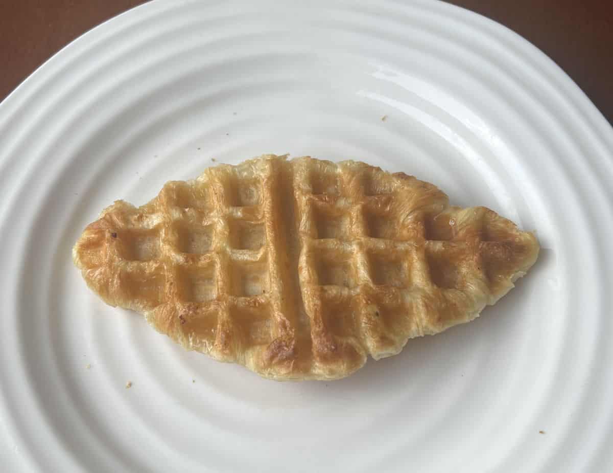 Image of one heated Croffle served on a white plate. 