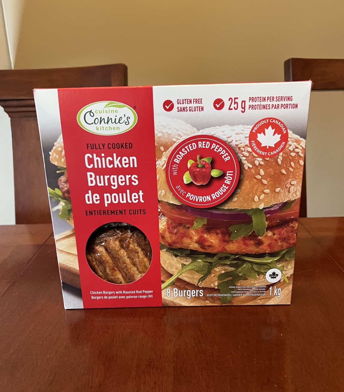 Image of the Connie's Kitchen Roasted Red Pepper Chicken Burgers box on a table unopened. 