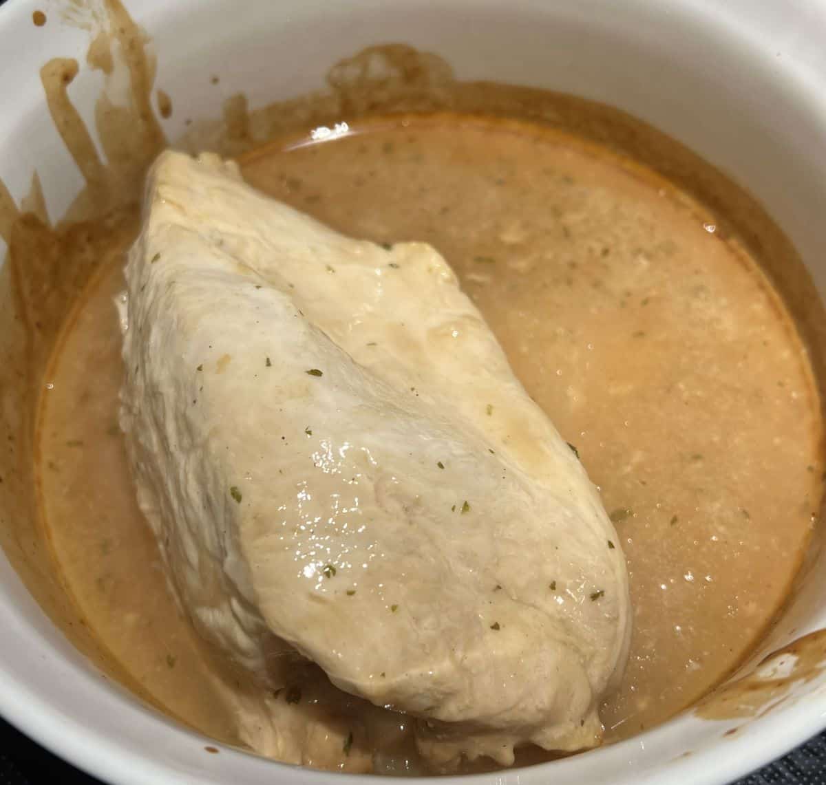 Image of a turkey breast in an oven safe dish after being heated.