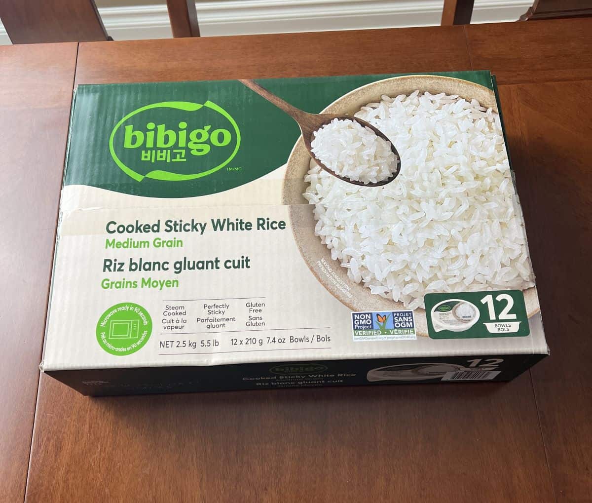 Image of the Costco Bibigo Cooked Sticky White Rice box sitting on a table unopened.