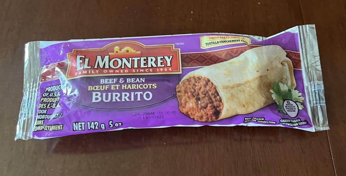 Image of one individually packaged burrito sitting on a table unopened.