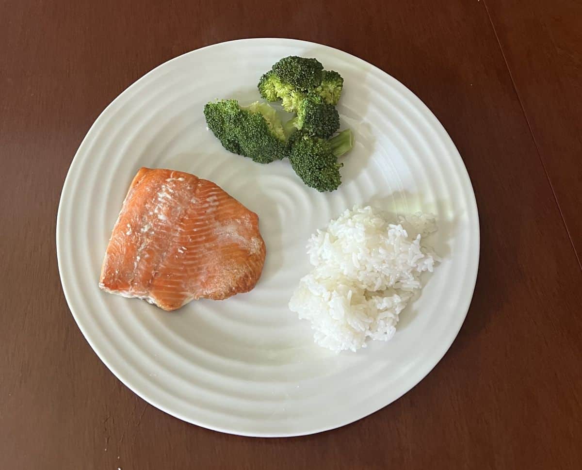 Image of a plate of rice, salmon and broccoli.