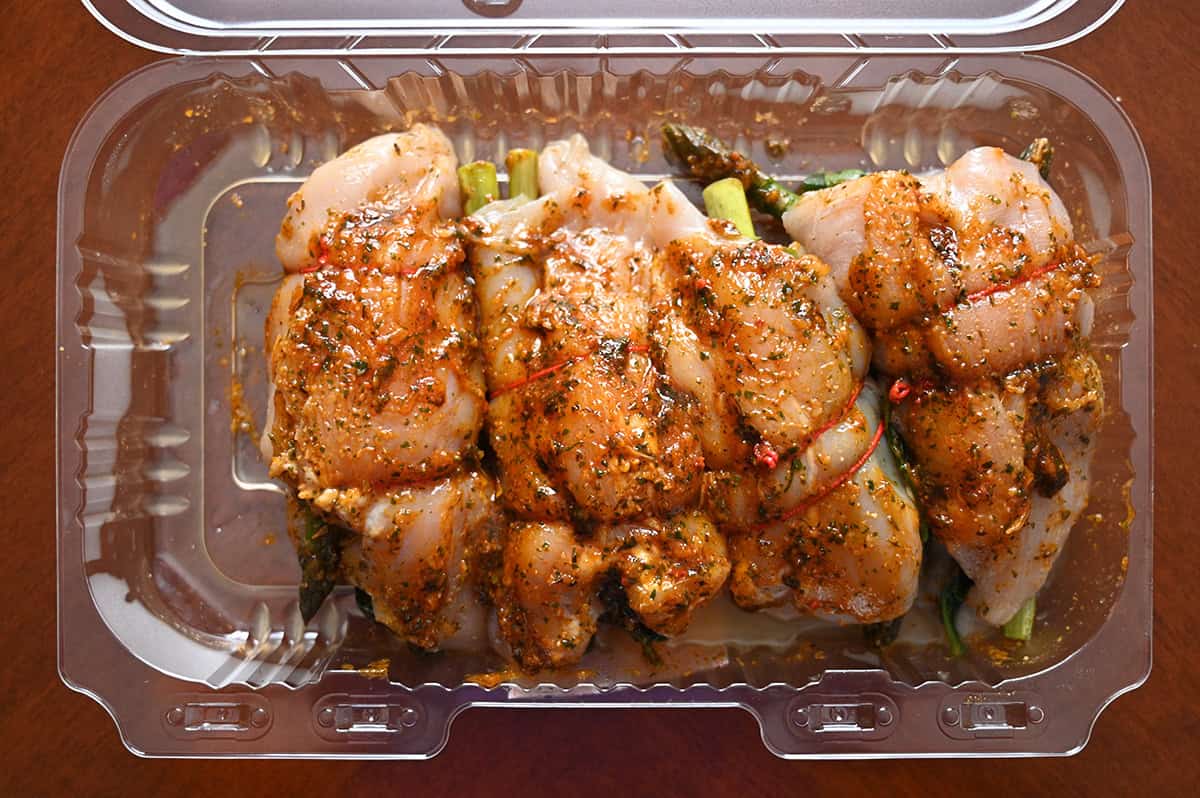 Image of the open container of the raw stuffed chicken breasts from Costco before cooking them. 