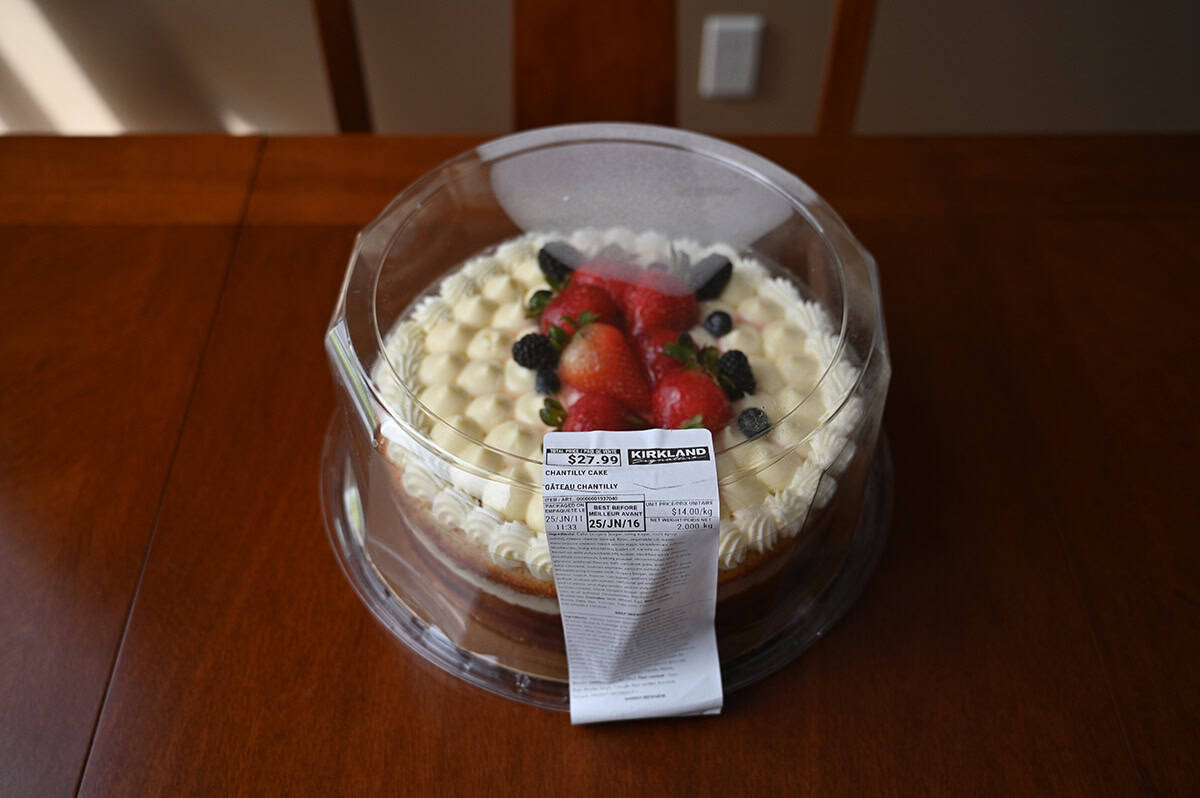 Image of the Costco Kirkland Signature Chantilly Cake sitting on a table unopened. 