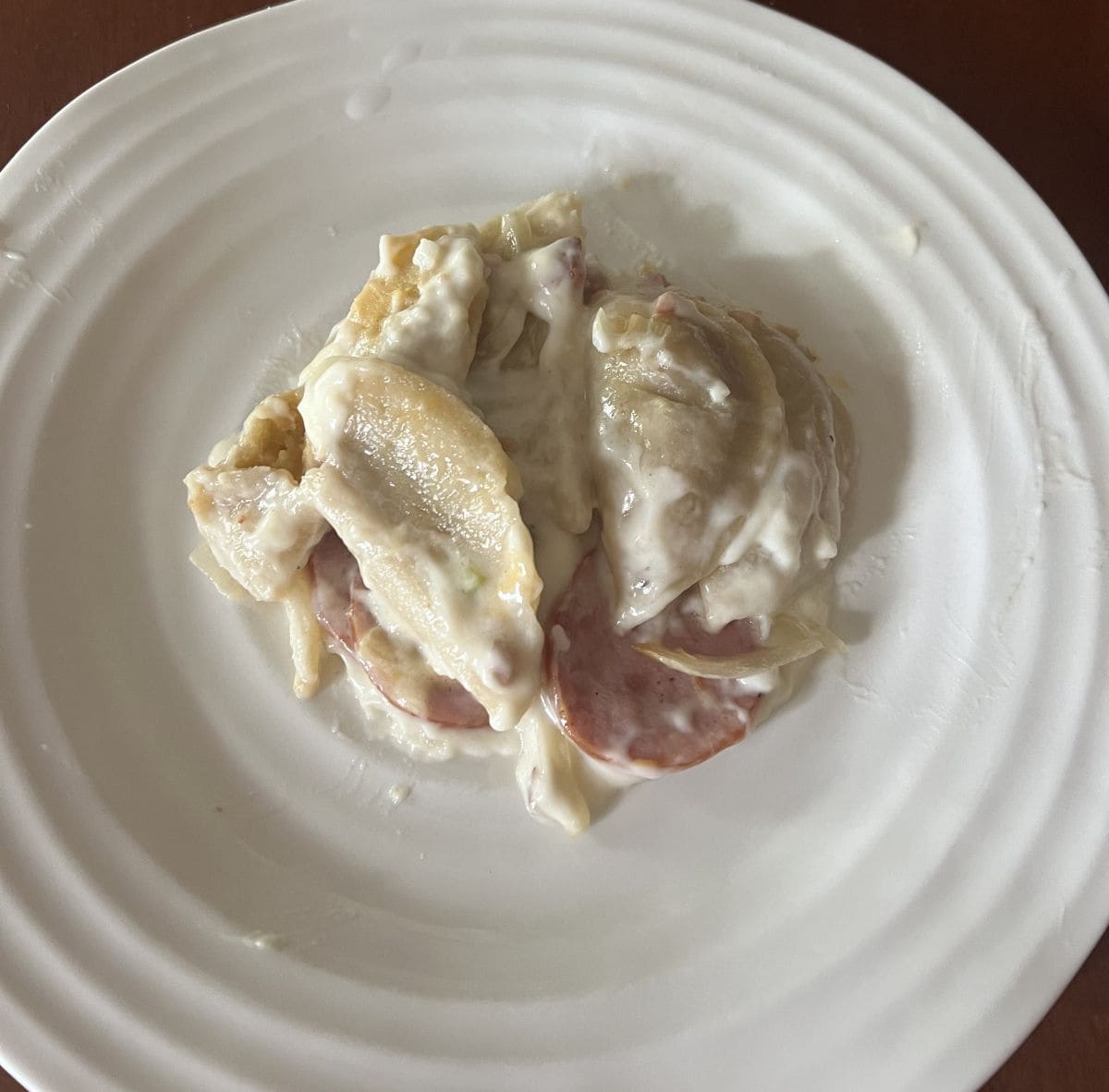 Top down image of a white plate with the pierogi bake served on it.
