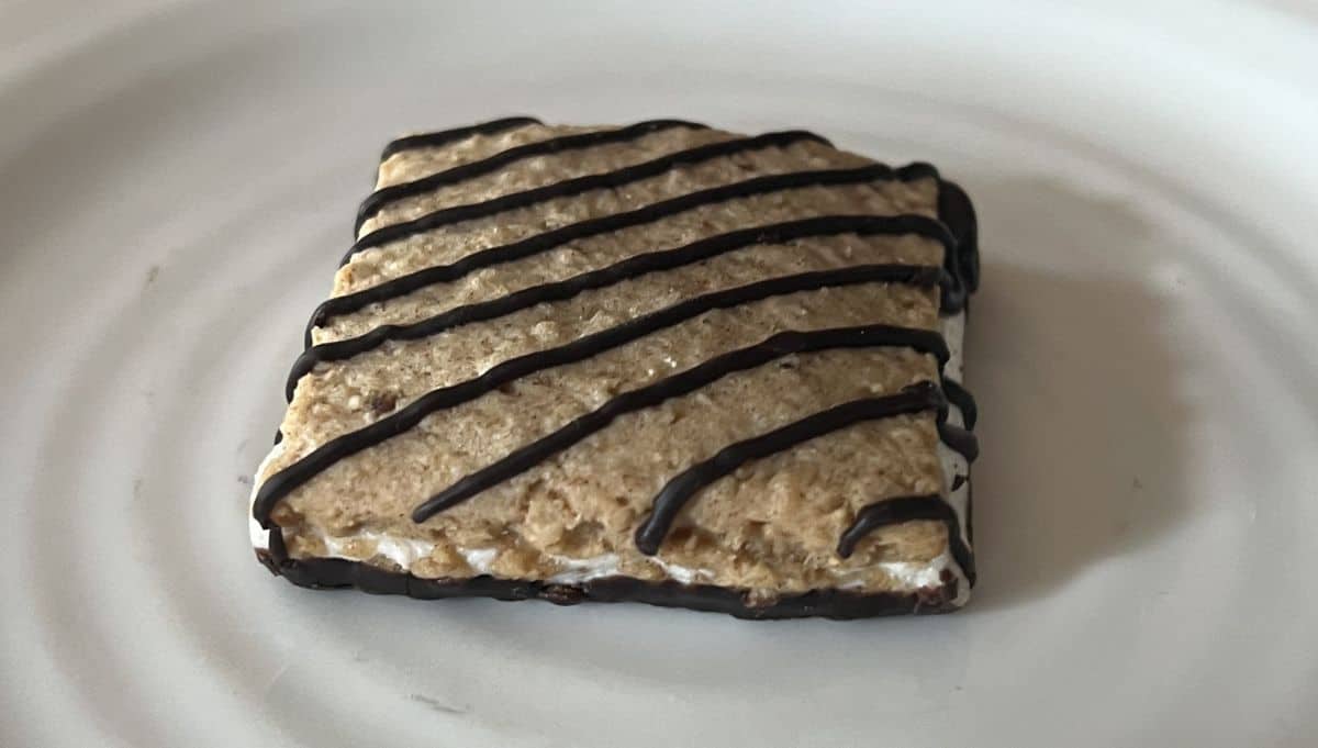 Closeup top-down image of one s'mores bar served on a white plate.