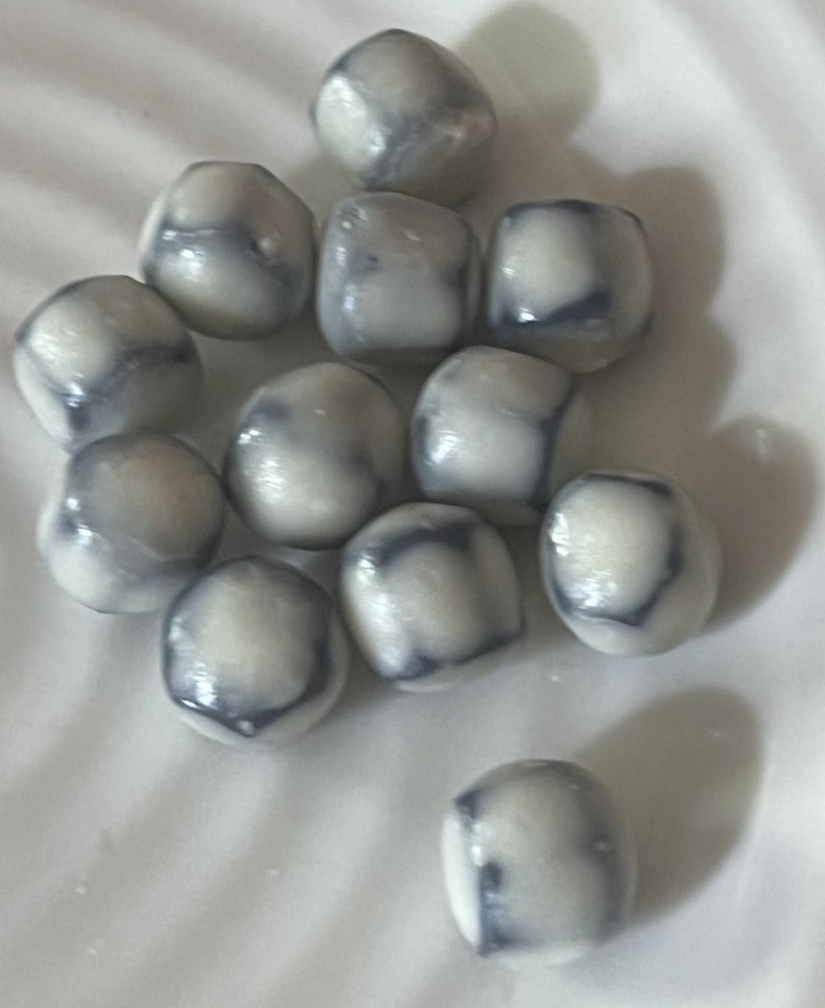 Closeup top down image of the blueberry-acai fruit snacks on a white plate.