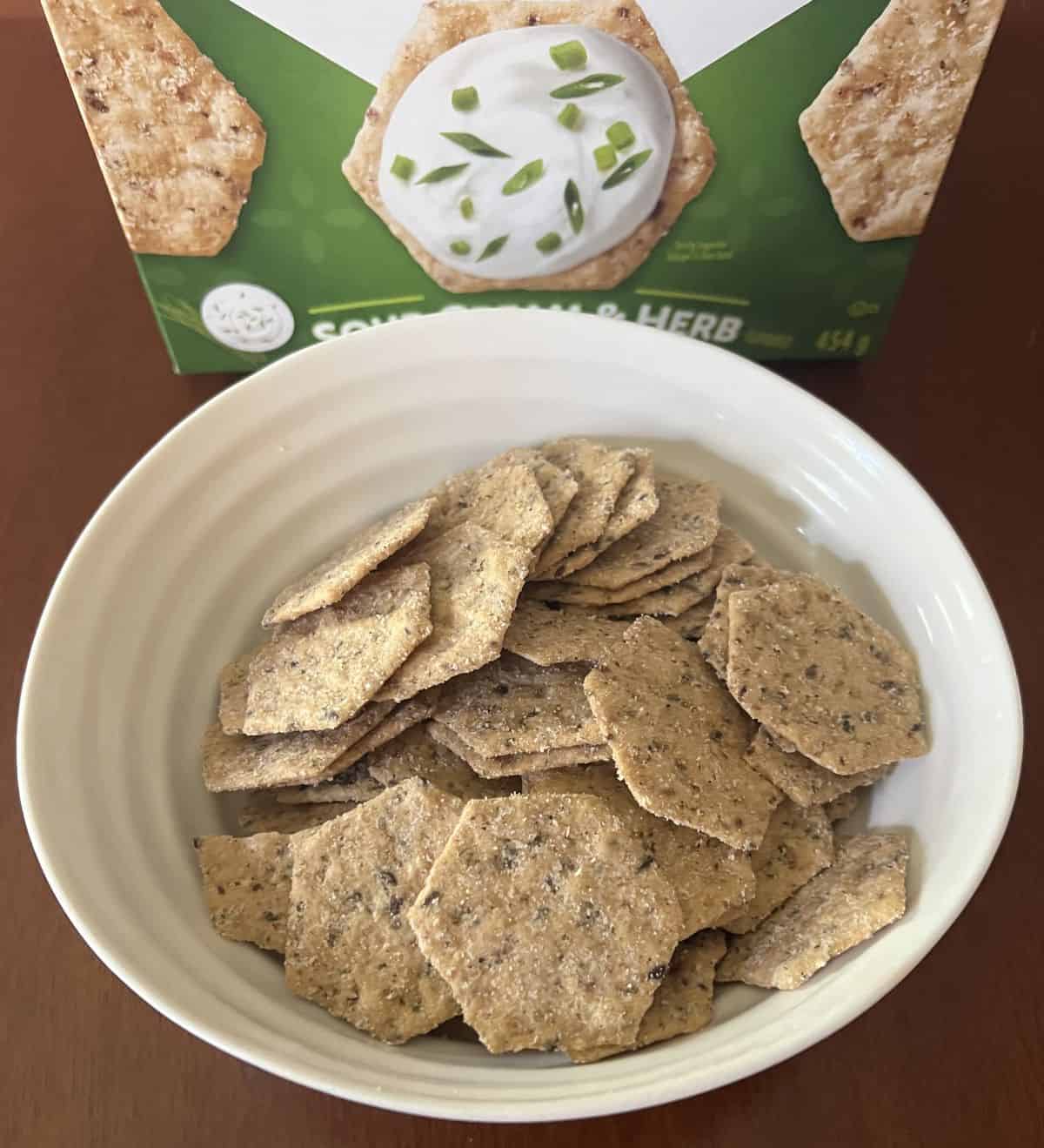 Image of the Costco Crunchmaster Sour Cream & Herb Crackers poured into a white bowl. 