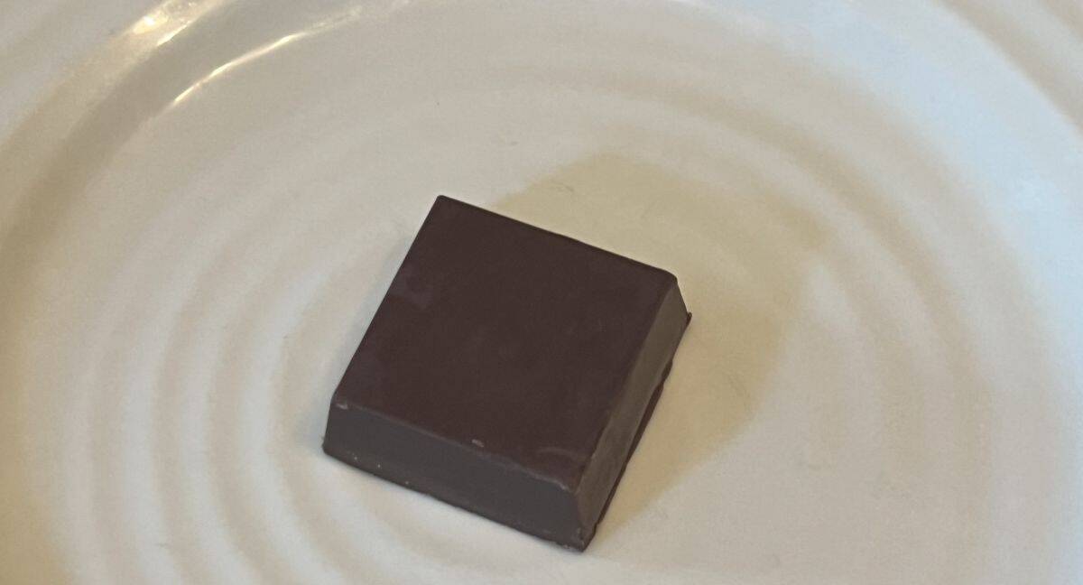 Top down image of one Dubai chocolate unwrapped sitting on a plate.