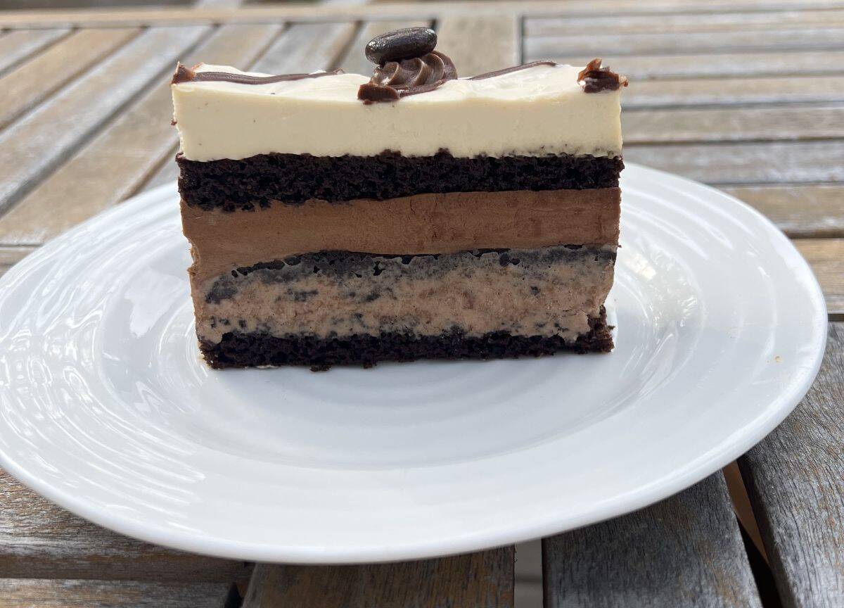 Image of one piece of cake standing up and served on a white plate.
