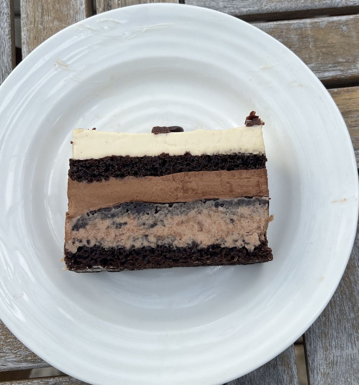 Image of a slice of Kirkland Signature Mocha Crunch Cake served on a white plate.