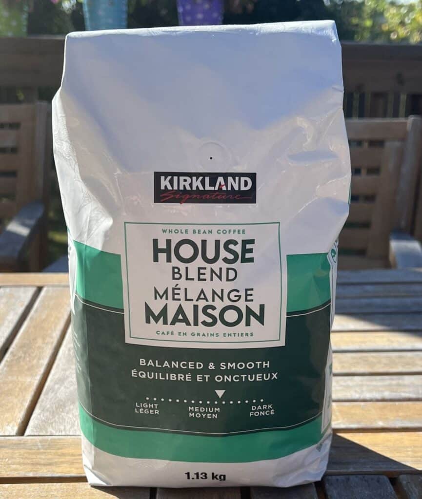 Image of one bag of the Costco Kirkland Signature House Blend Coffee Medium Roast sitting on a deck outside unopened. 