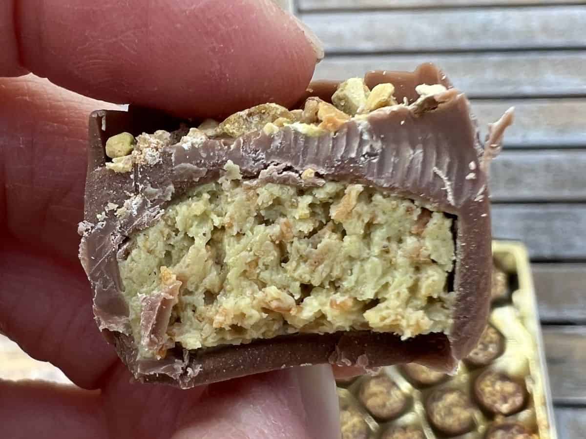 Closeup image of one Dubai chocolate that's been cut in half so you can see the middle.