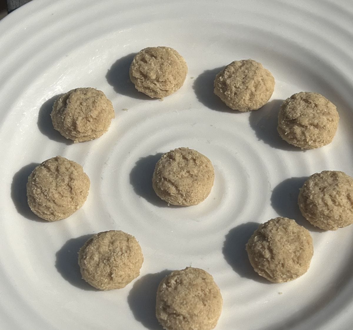 Closeup image of the mini crunchy cookies served on a white plate.