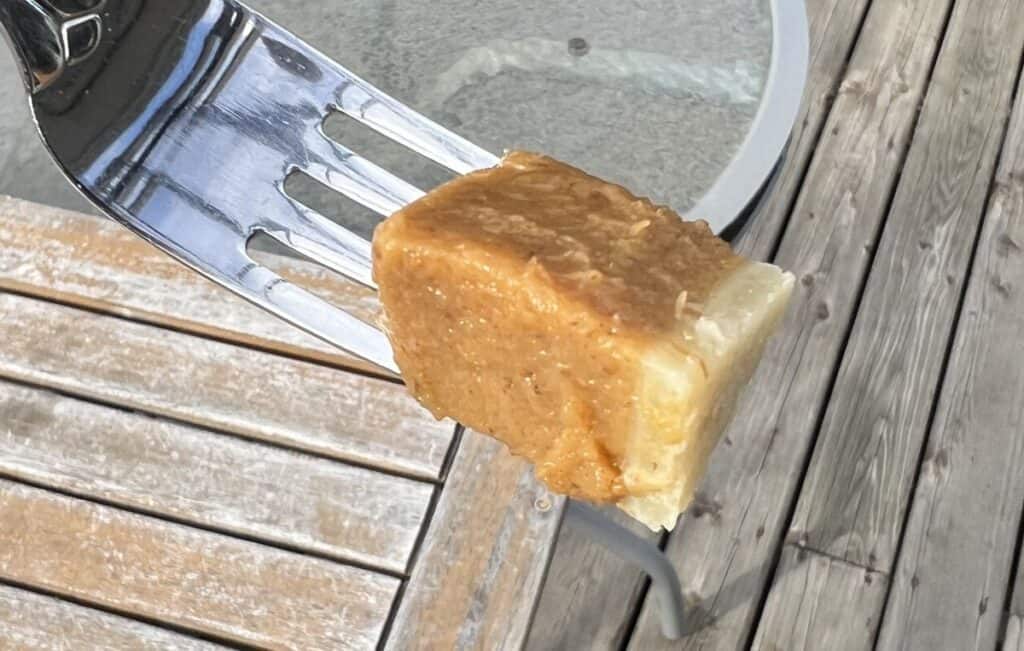 Image of a fork with a bite of pie on it so you can see an underbaked crust. 