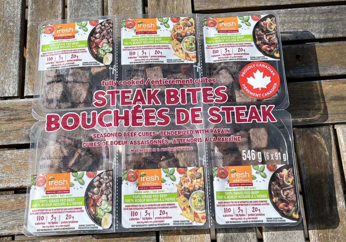 Image of the Costco Fresh Additions Steak Bites package sitting on a table unopened.